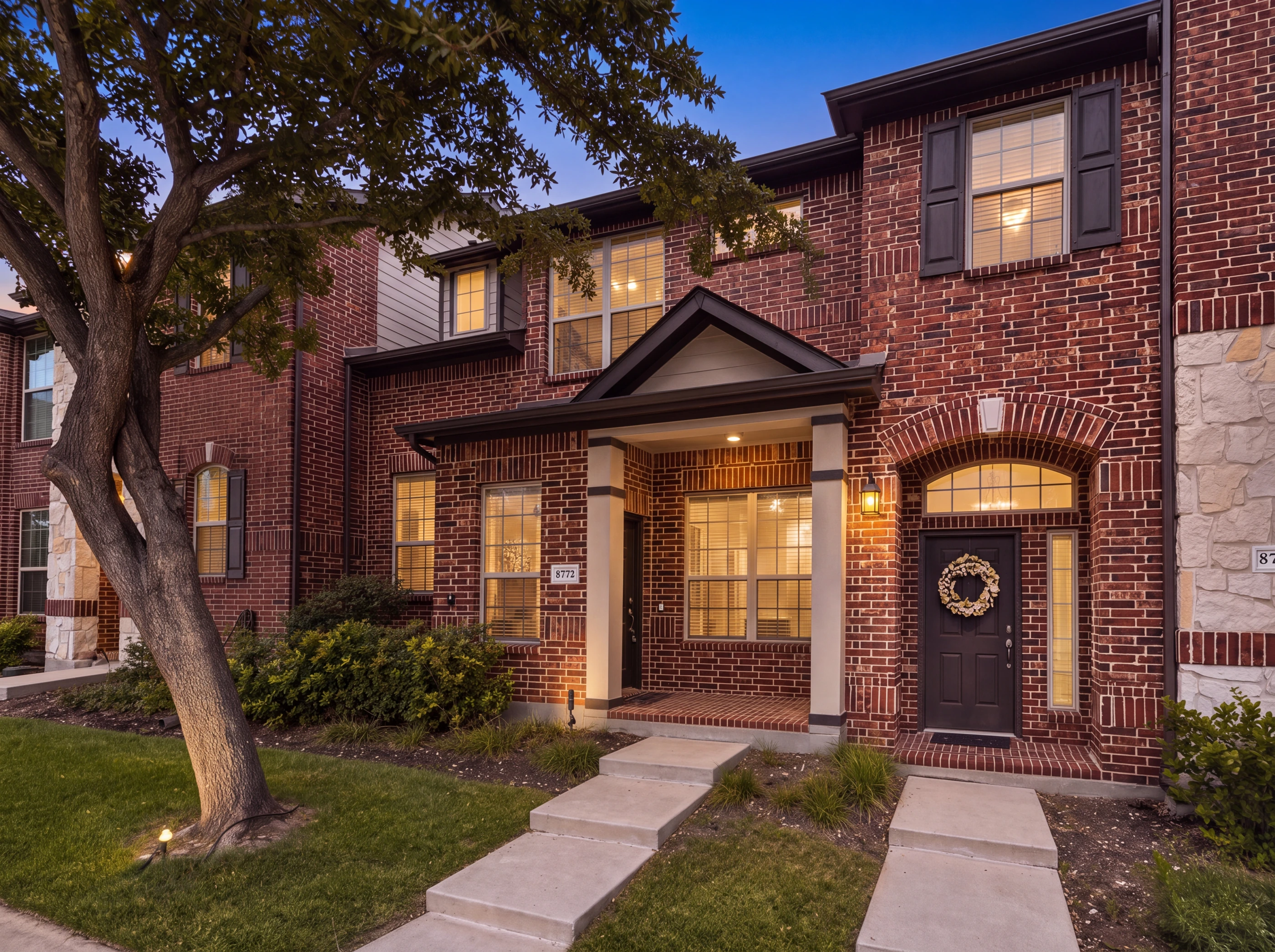 Brick townhome elevation at dusk