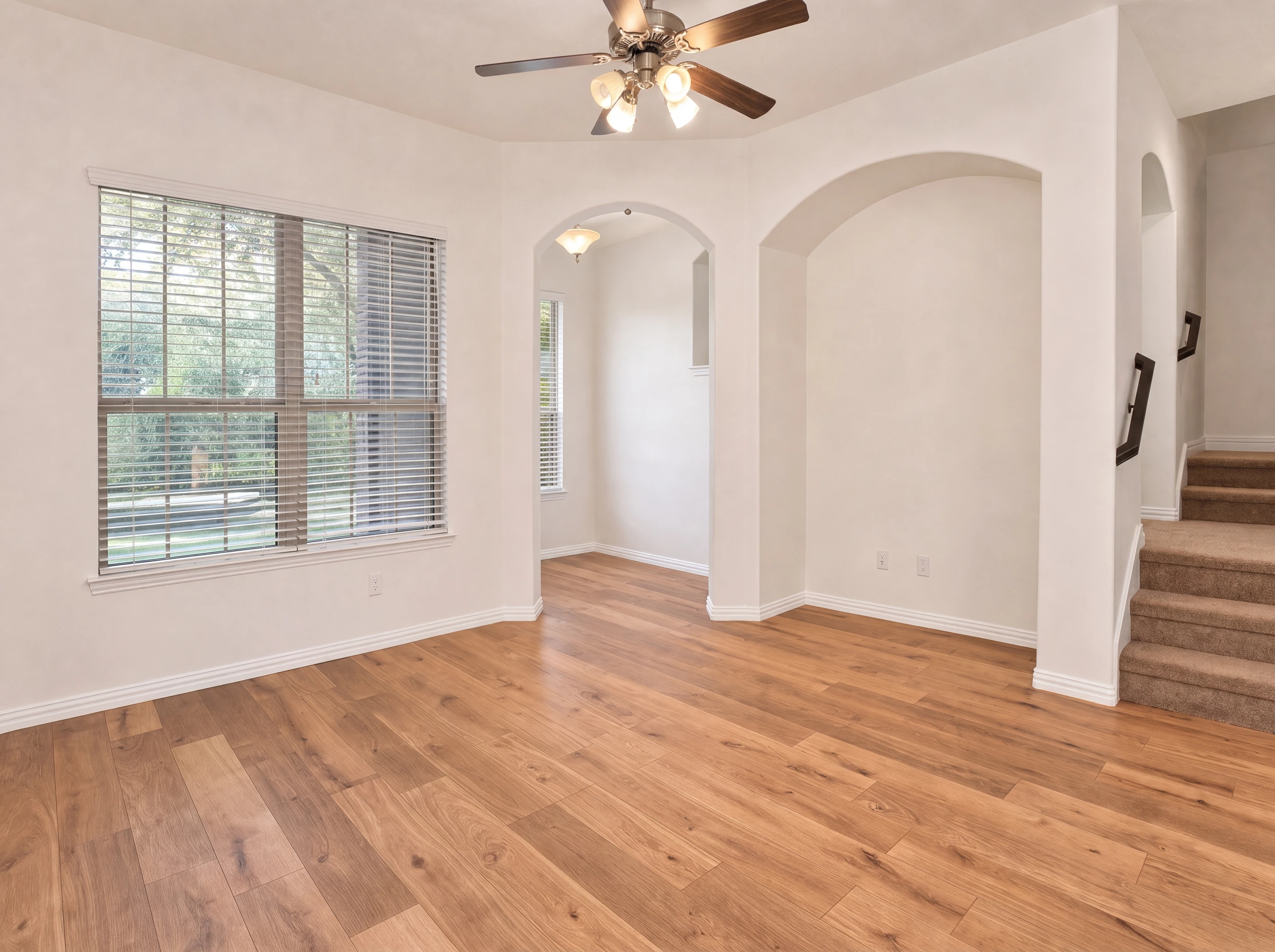 Second living area with arched openings and staircase
